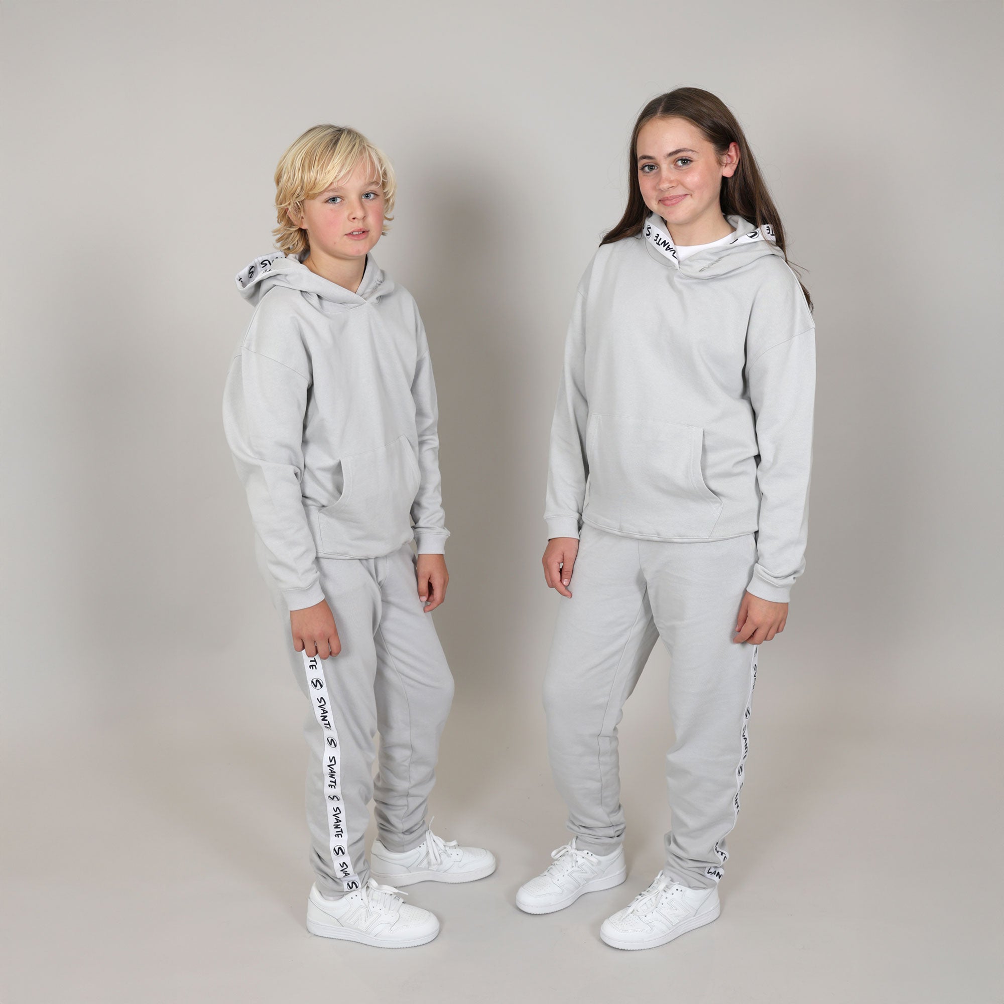 girl and boy wearing grey Svante hoody and joggers made from regenerative cotton