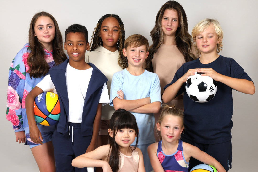 Svante Group of children wearing natural material and organic sports shorts, sports leggings and sports t-shirts, and sports crop top