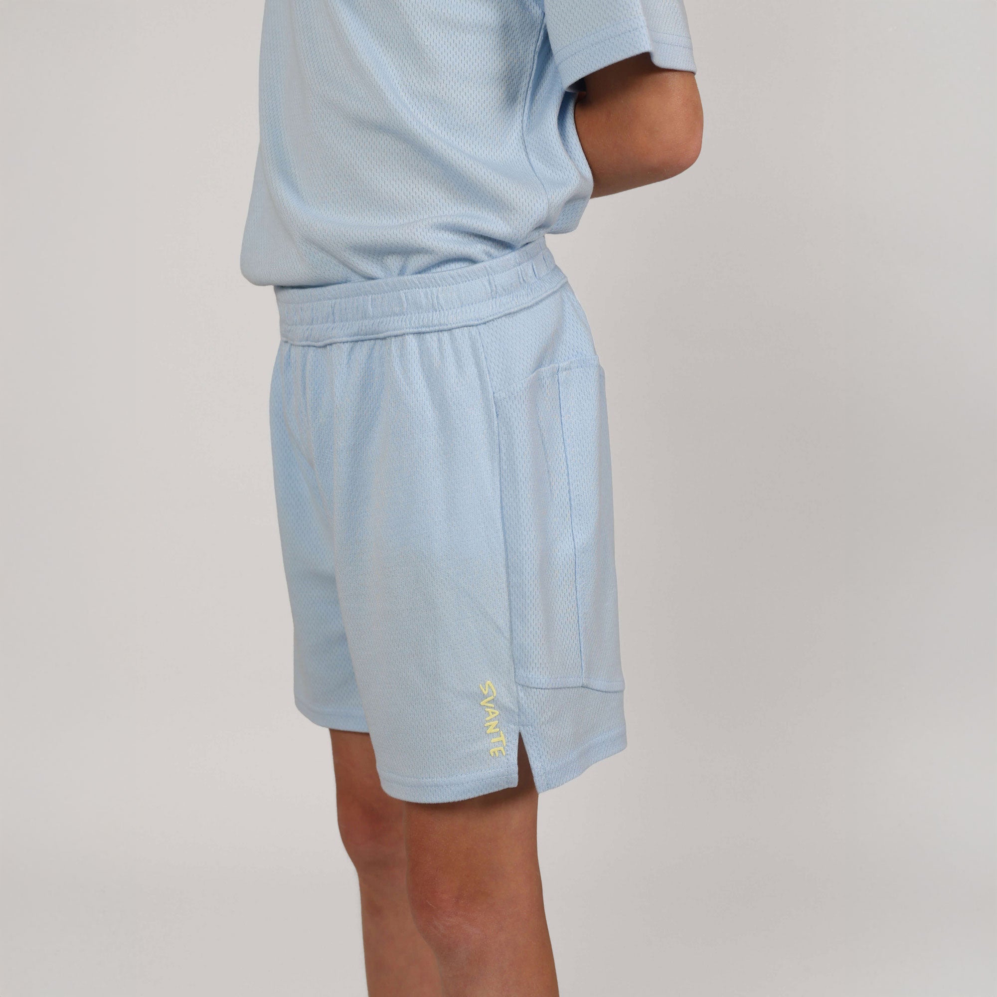 boy wearing sky blue colour Svante natural material sports shorts with Svante logo
