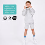 Boy wearing organic cotton grey jersey shorts and a grey organic cotton hoodie with text about regenerative and organic cotton, and certification logos. 