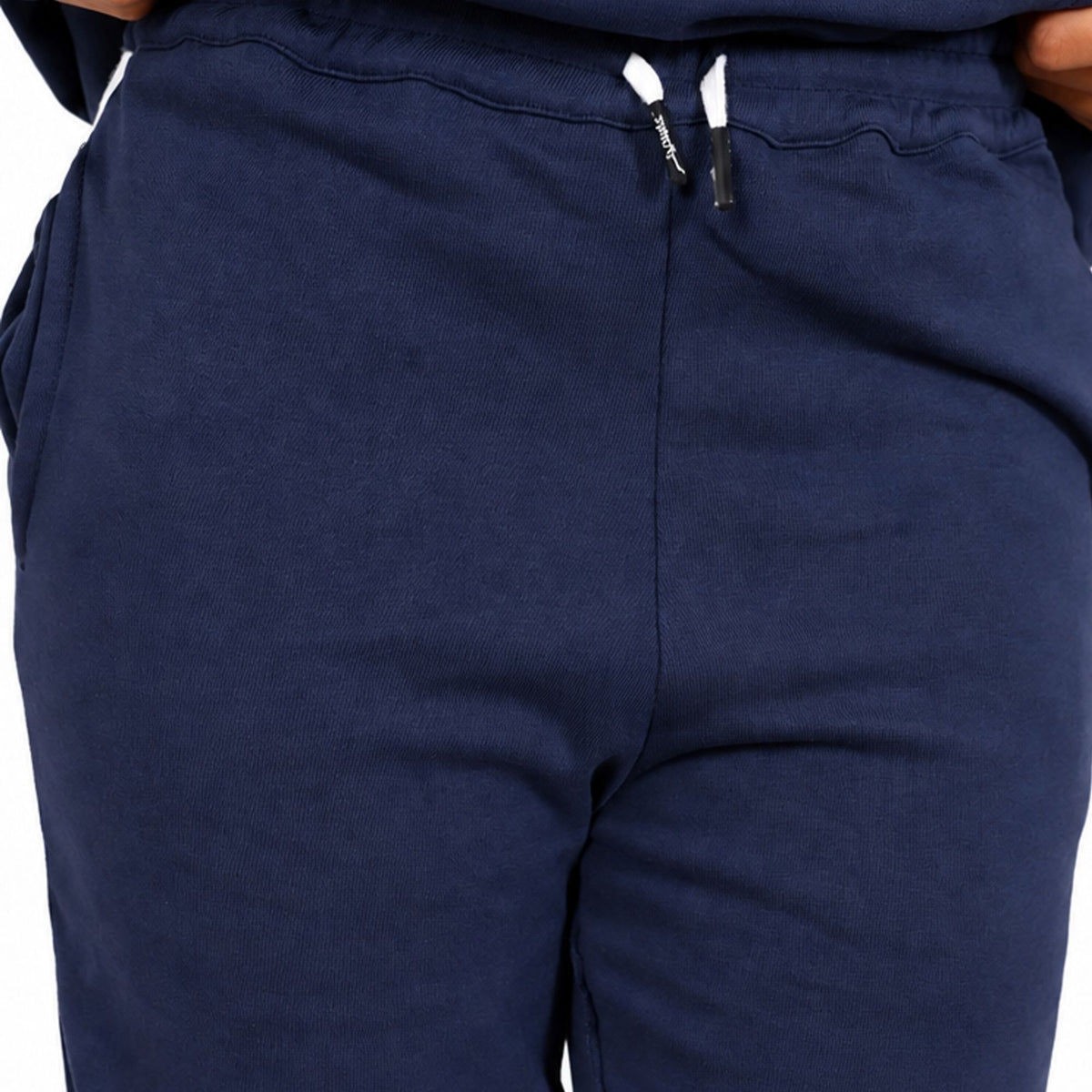 Close-up of Svante regenerative cotton navy blue sweatpants showing the front waistband with white drawstrings and side pockets.