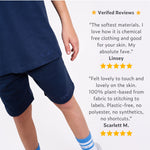 Boy wearing regenerative cotton navy blue shorts with positive reviews displayed on a white background. 