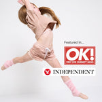 Girl doing gymnastics in pink organic cotton crop top, sports bra and pink sports shorts, with ballet shoes with OK! magazine and Independent logos. 